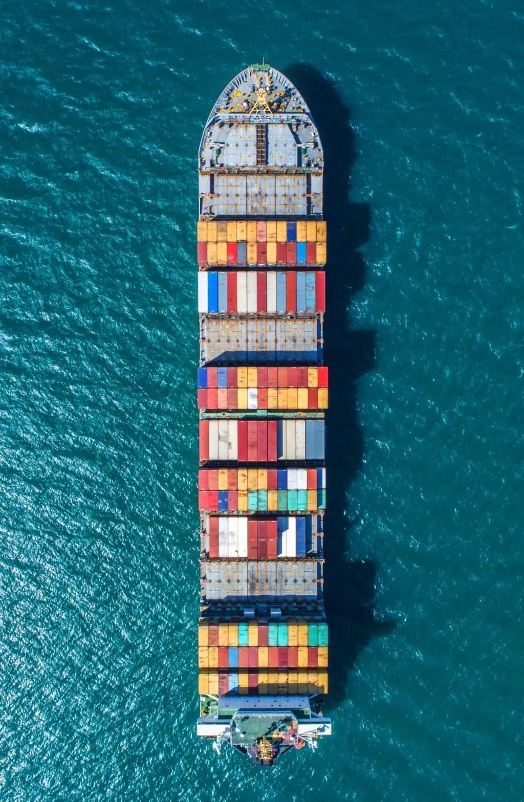 Aerial view of an Ironclad Global Freight container vessel crossing open ocean