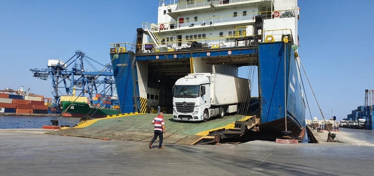 Heavy machinery loading onto an Ironclad Global Freight RORO vessel at port